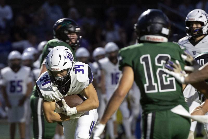 Dixon’s Owen Belzer punches it in for a TD against Rock Falls Friday, Sept. 13, 2024, at Hinders Field in Rock Falls.