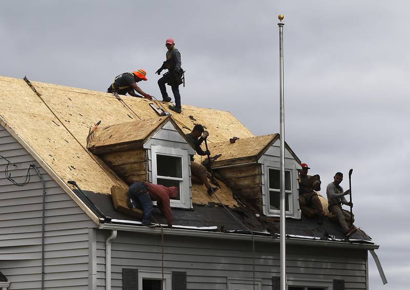 Workers for XL Contracting install a new roof on the home of U.S. Army veteran Philip Arnold on Thursday, Sept. 7, 2023, through the Owens Corning Roof Deployment Project and Habitat for Humanity.