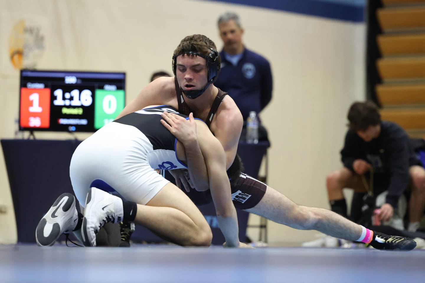 Joliet Catholic’s Connor Cumbee works over Lincoln-Way East’s Domanic Abeja in the Class 3A dual team sectional at Downers Grove South High School on Tuesday, Feb. 20th 2024.