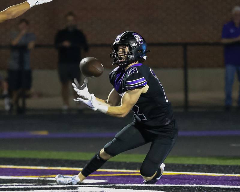 Downers Grove North's Max Troha (12) comes down with a touchdown during a football game between Glenbard West at Downers Grove North on Friday, Sept 13th, 2024  in Downers Grove.