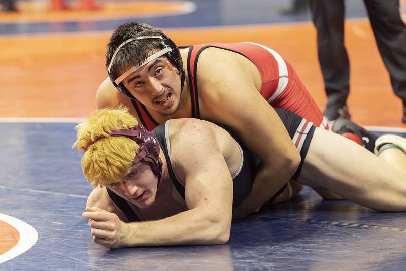 Prairie Ridge’s Josh Fallaw (bottom) is worked on by Jacksonville’s Olive Cooley in the 215 pound third place 2A match Saturday, Feb. 17, 2024 at the IHSA state wrestling finals at the State Farm Center in Champaign.