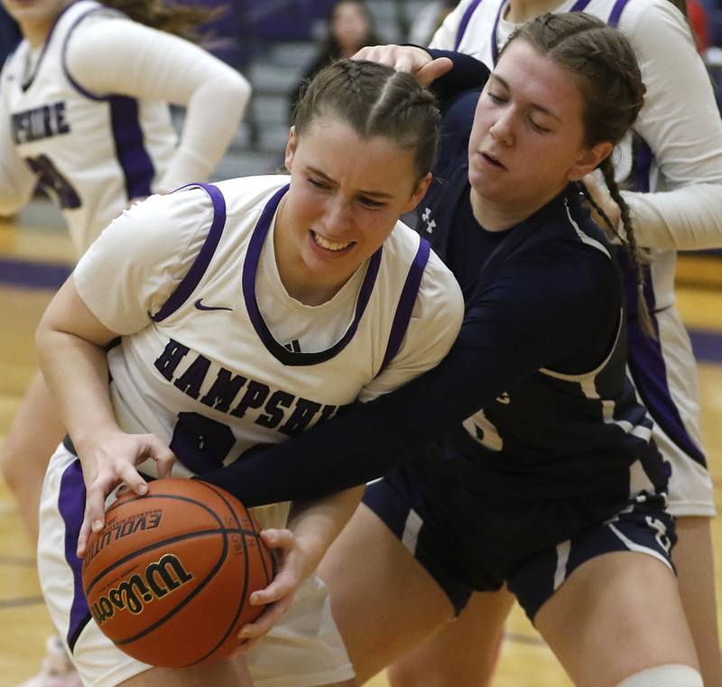 Cary-Grove's Ellie Mjaanes (right) reaches for the ball against Hampshire's Whitney Thompson during a Fox Valley Conference girls basketball game Friday, Jan. 26, 2024, at Hampshire High School.