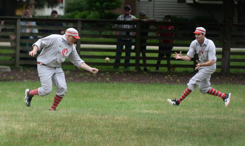 Ganymede Brandon Jens (left) reaches for hit as Mike "Smitty" Smith enters the play during a vintage base ball game against the DuPage Plowboys at the John Deere Historic Site in Grand Detour on Saturday, June 8, 2024. Jens is a branded property manager for John Deere and joined the Ganymedes for the game at the historic site.