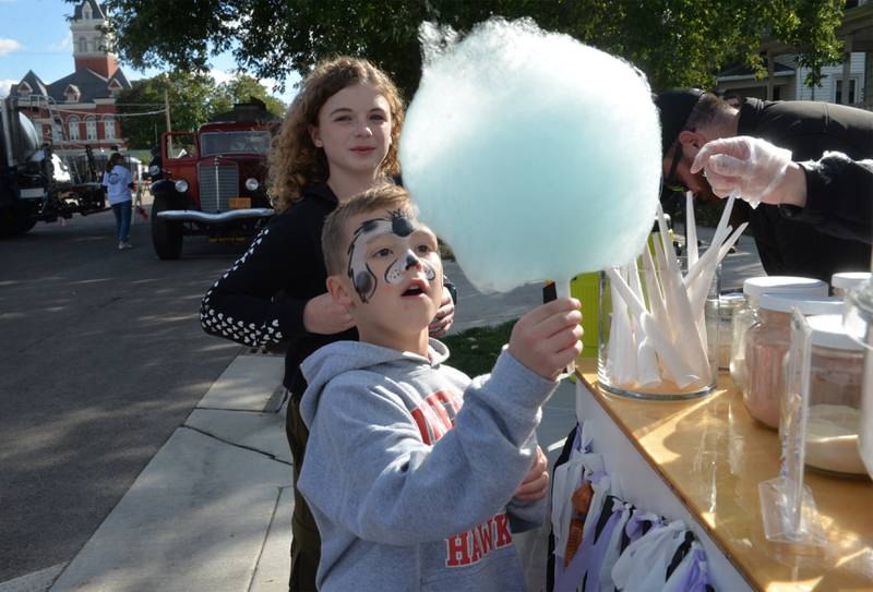 Logan Smith, 6,, of Oregon, gets ready to taste his blue raspberry flavored cotton candy made by Chelsea Hamilton of Cotton Candy Smiles during Autumn on Parade on Saturday, Oct. 7, 2023. The cotton candy maker was one of the vendors in the Fun Zone for kids.