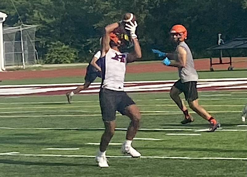 Romeoville's Ty English snatches a pass during a recent 7 on 7 competition at Morris.