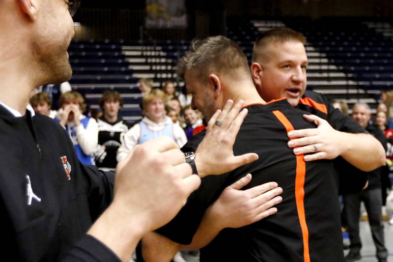 McHenry Head Coach Corky Card is hugged by assistant coach John Niemic after Card secured his 300 career win against Hononegah in the IHSA Class 4A Guilford Boys Basketball Sectional semifinal game on Wednesday, Feb. 28, 2024, at Rock Valley College in Rockford.