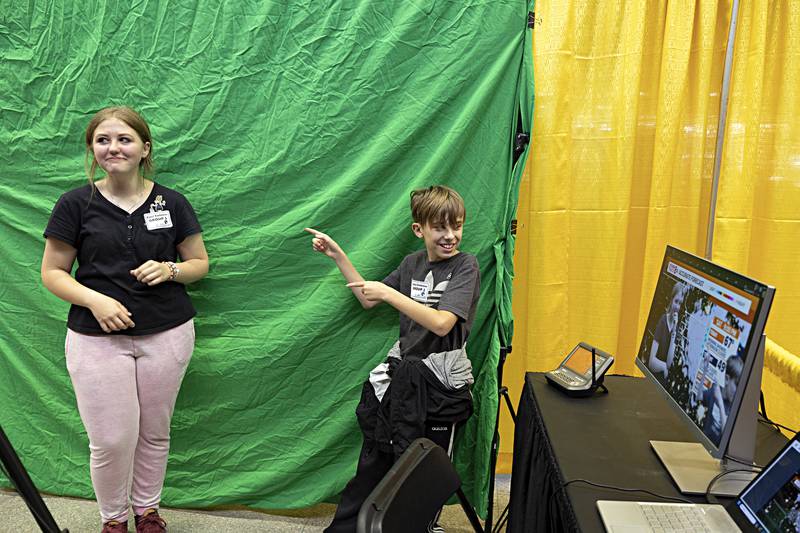 Daniel Galkowski points towards Annalis Jones eighth-graders at East Coloma-Nelson School as they try out a green screen as presented by meteorologist Andrew Stutzke of WQAD Friday, Oct. 20, 2023.