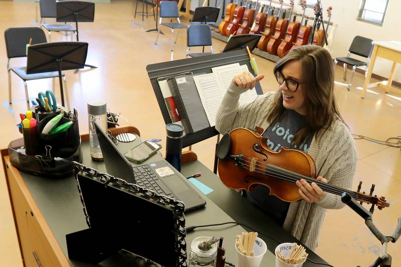 Woodstock North and Northwood Elementary school orchestra teacher Stacie Savittieri conducts an orchestra class with her students over Google Meet on Wednesday, Dec. 9, 2020, at Woodstock North High School in Woodstock.