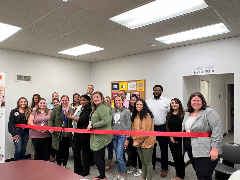 Sharkisha Jones, Birth to Five Illinois Region 24 Council Manager, cuts the ribbon at the Grundy County Chamber of Commerce ribbon cutting held for the new office in July. Jones is joined by Birth to Five staff and supports, along with Chamber Ambassadors and staff