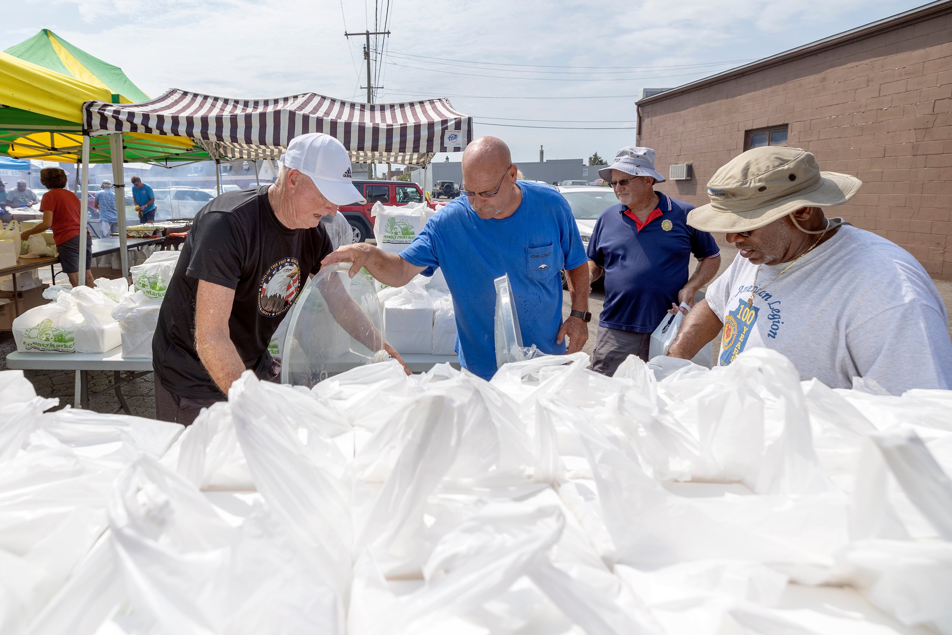 Legion members bag up chicken meals for pickup Monday, Aug. 5, 2024, in Sterling.