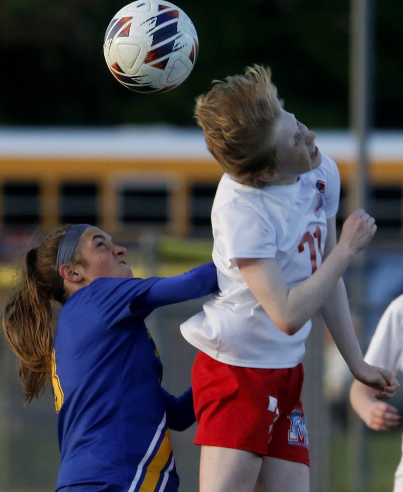 Marian Central'a Natalee Henkel heads the ball away from Johnsburg's Charlie Eastland during the IHSA Class 1A Marengo Regional championship soccer match on Tuesday, May 14, 2024, at Marengo High School.