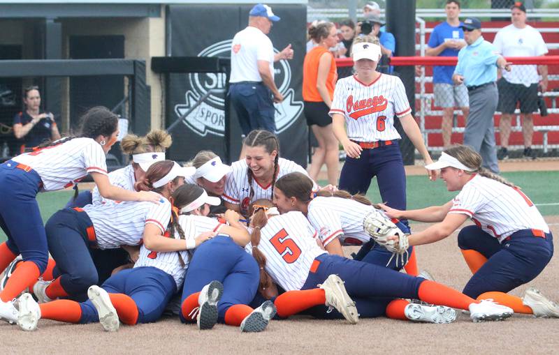 Members of the Oswego softball team pile on at the mound after winning third place in Class 4A on Saturday, June 8, 2024 at the Louisville Slugger Sports Complex in Peoria.