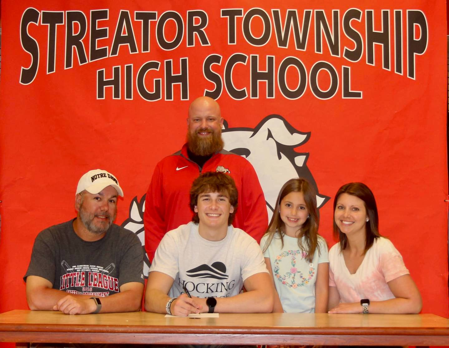 Recent Streator High School graduate Cade Stevens has committed to continue his academic career at Hocking College and his football career at the NJCAA level with the Hawks. Pictured here is Stevens seated alongside family members Brett (father), Kinsley (sister) and Marita (mother), with Streator High head football coach Kyle Tutt standing behind.