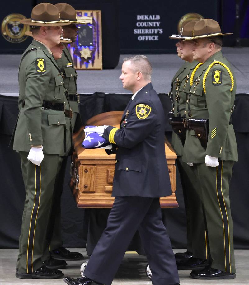 DeKalb County Sheriff Andy Sullivan walks the flag from the casket of DeKalb County Sheriff’s Deputy Christina Musil over to her family Thursday, April 4, 2024, during her visitation and funeral in the Convocation Center at Northern Illinois University. Musil, 35, was killed March 28 while on duty after a truck rear-ended her police vehicle in Waterman.