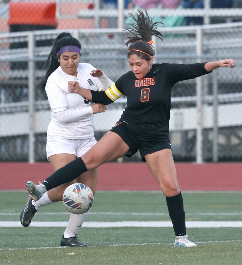 DeKalb's Carla Murrieta kicks the ball away from Belvidere North's Adrianely Galicia during their game Tuesday, March 12, 2024, at DeKalb High School.