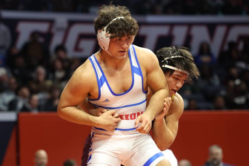 Marmion’s Joseph Favia escapes Loyola’s Kai Calcutt in the 215-pound Class 3A state championship match on Saturday, Feb. 17th, 2024 in Champaign.