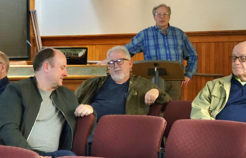 Michael Stumpf, principal owner of Place Dynamics of New Berlin, Wis., (standing) fields a question from Ottawa commissioners Tom Ganiere (from left) and Brent Barron during Thursday's public meeting regarding a feasibility study on downtown upper-level residences.