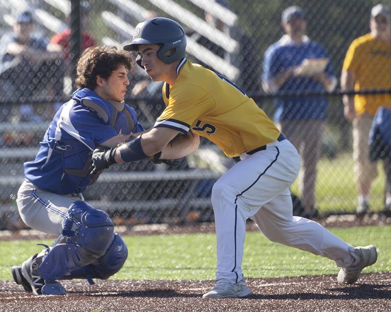 Sterling’s Mason Smithee is tagged out by Princeton’s Ace Christiansen trying to score on a sacrifice Tuesday, May 7, 2024 at Sterling’s Gartner Park.