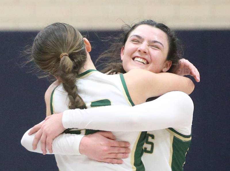 St. Bede's Ali Bosnich hugs teammate Ella Hermes after defeating Amboy in the Class 1A Regional final game on Friday, Feb. 16, 2024 at Marquette High School.