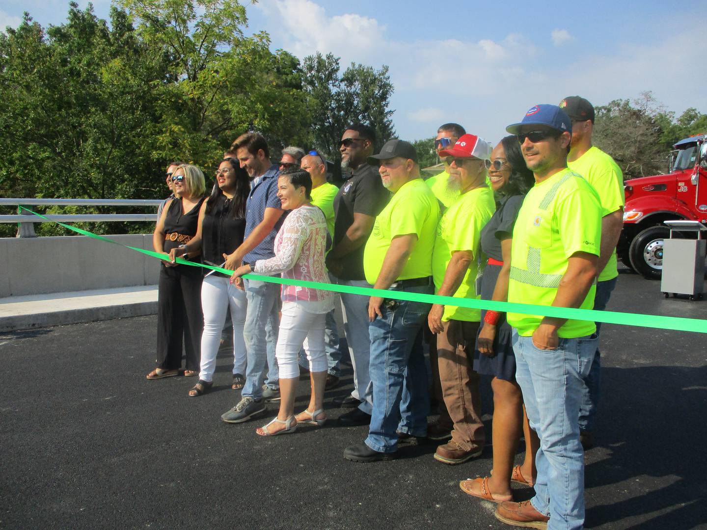 Joliet Township officials and township highway workers gather for a ribbon-cutting Monday for the new bridge that carries Sugar Creek Road over Sugar Creek. Aug. 26, 2024