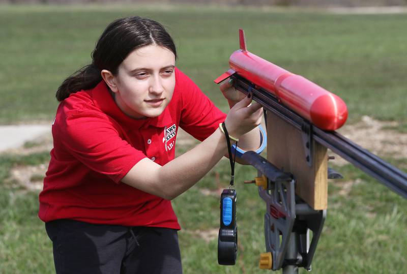 Lilly Abney, 14, of Round Lake Beach, with the Prince of Peace Redhawk Rocketeers TARC Team puts a rocket on the launch pad during the last practice launch to compete in the upcoming American Rocketry Challenge at the Tim Osmond Sports Complex in Antioch. The finals are held next month in Washington, D.C. on May 14th.