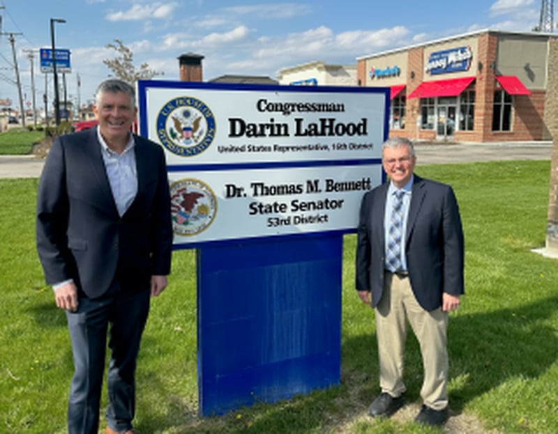 16th District Congressman Darin Lahood (R-Dunlap) and State Senator Tom Bennett (R-Gibson City) with the sign outside their new office at 1715 N Division Street Suite E in Morris.
