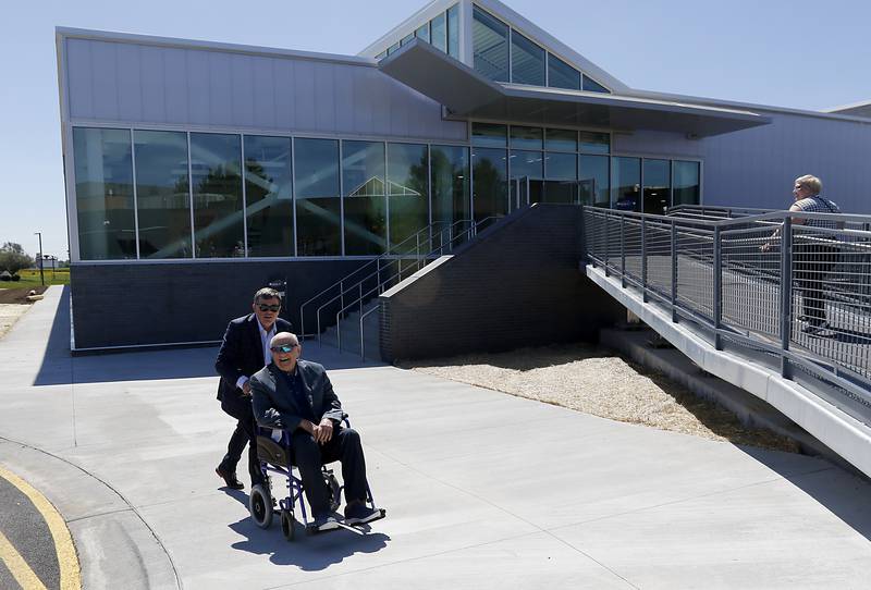 Vince Foglia and his son, Vinnie, head into the Foglia Center for Advanced Technology and Innovation during the opening ceremony on Tuesday, Sept. 3, 2024, at McHenry County College.