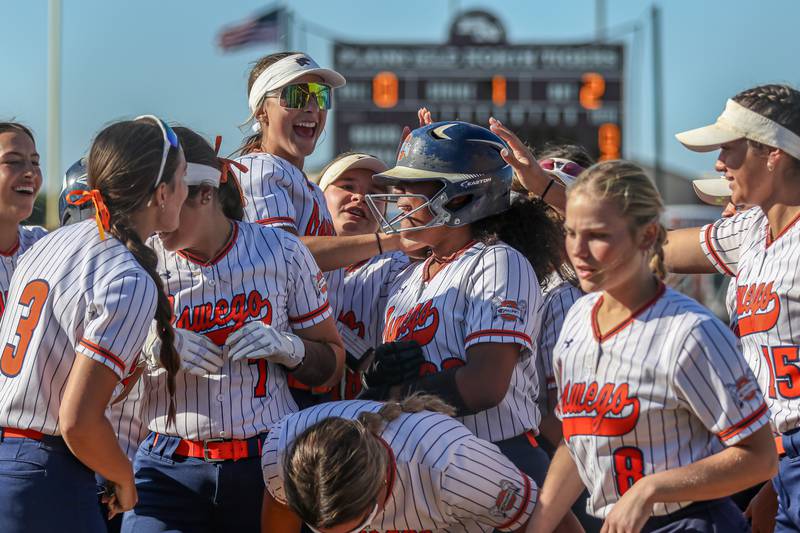 Oswego's Jaelynn Anthony (20) is greeted by teammates at the plate after hitting a home run during Class 4A Plainfield North Sectional semifinal softball game between Wheaton-Warrenville South at Oswego. May 29th, 2024.