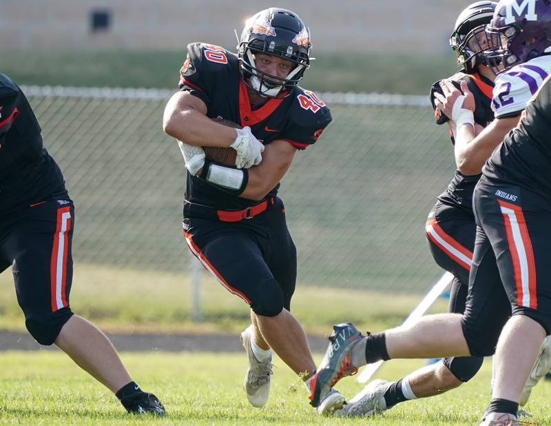 Sandwich Parker Anderson (40) carries the ball against Manteno during a football game at Sandwich High School on Saturday, Aug 26, 2023.