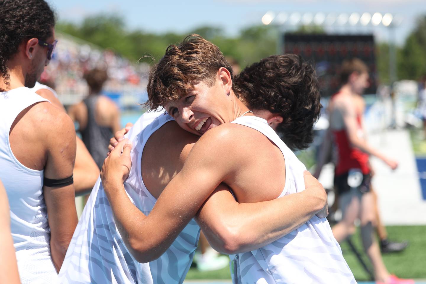 Plainfield North’s Owen Stahl hugs a teammate after finishing third in the Class 3A 3,200-meter run at the IHSA State Meet held Saturday, May 25, 2024, in Charleston.