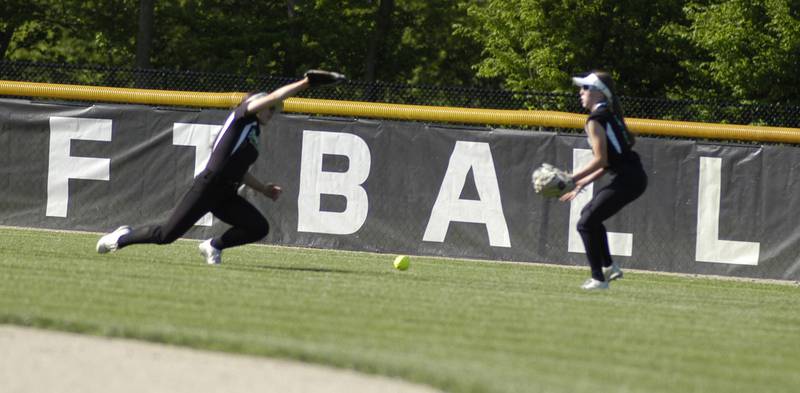 An Oregon single drops between Rock Falls' Emma Skinner (left) and Jeslyn Krueger on Monday, May 6, 2024 in Rock Falls.