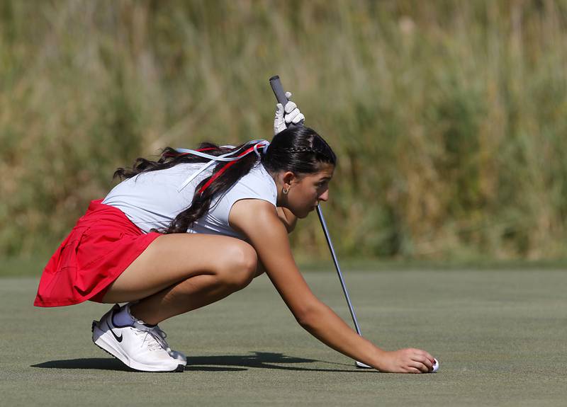 Marian Central’s Nina Notaro lines up a putt on the 5th green of the Valley course during the McHenry County Tournament on Thursday, Sept.12, 2024, at Boone Creek Golf Club in Bull Valley.