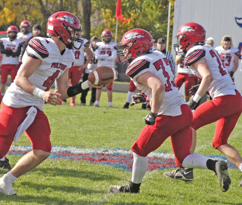 Fulton QB Don Kramer hands the ball off to RB Skylier Crooks in round one of the Class 1A football playoffs.