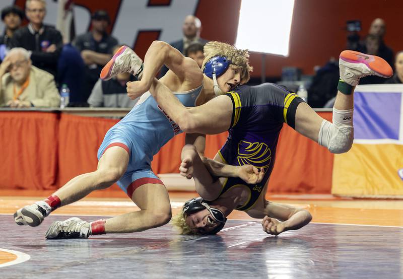 Marian’s Central’s Brayden Teunissen flips Carlye’s Tyson Waughtel for a sudden death score in the 1A 120 pound championship match Saturday, Feb. 17, 2024 at the IHSA state wrestling finals at the State Farm Center in Champaign.