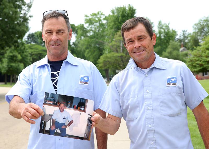 Jeff and Jay Gerber hold a photo of their father Bill at the corner of Bucklin and Oconor Avenue on Monday, May 20, 2024 in La Salle. The family has been delivering the mail for the United States Postal Service for a combined 60 years in the Illinois Valley. The brothers have recently retired from the USPS.