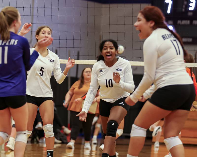 Plano's Kalia Young (10) celebrates with teammates during volleyball match between Sandwich at Plano.  August 21, 2023.