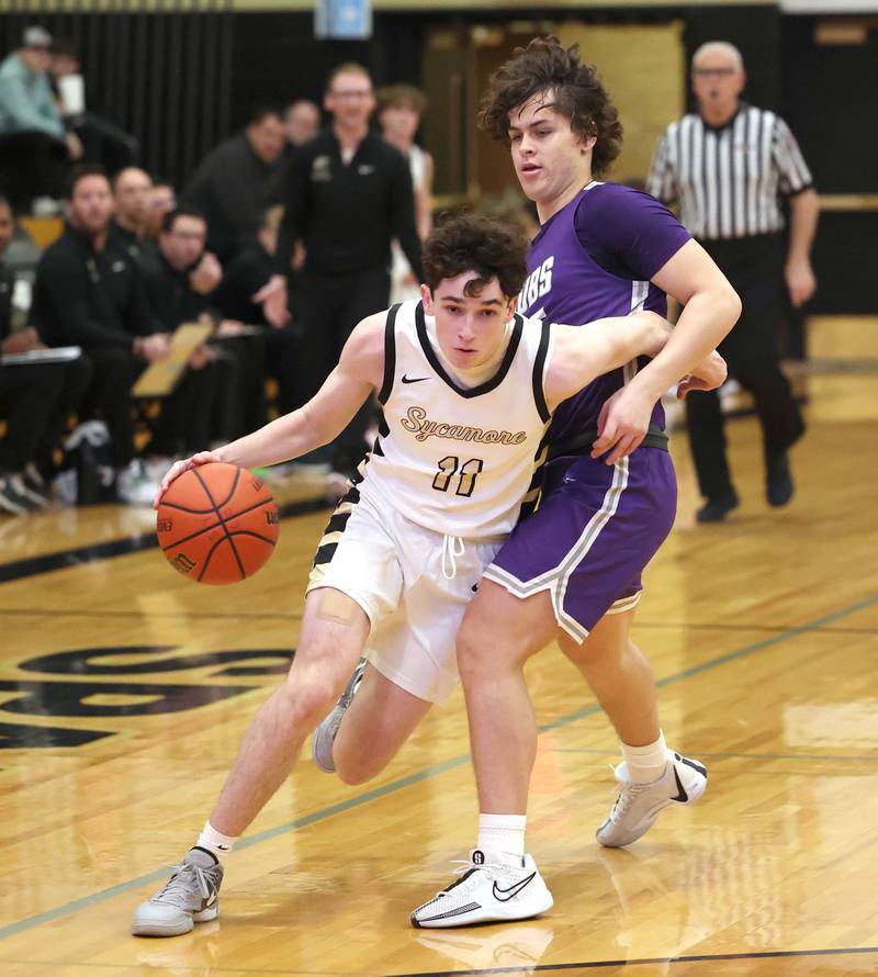 Sycamore's Jake Shipley drives by Rochelle's Jack Tracey during their game Tuesday, Dec. 5, 2023, at Sycamore High School.