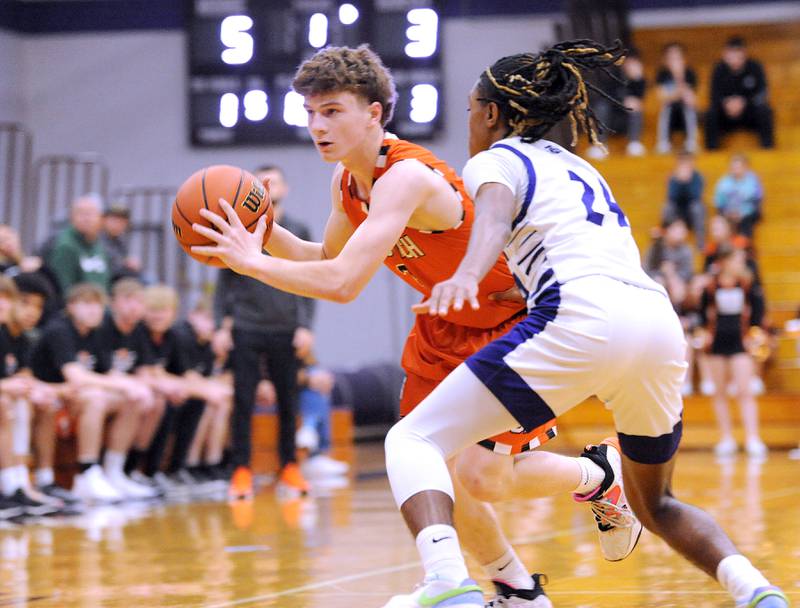 Sandwich's Griffin Somlock brings the ball up court against the press from Plano defender Ta'ron McGowan (24) during a varsity basketball game at Plano High School on Tuesday, Dec. 5, 2023.