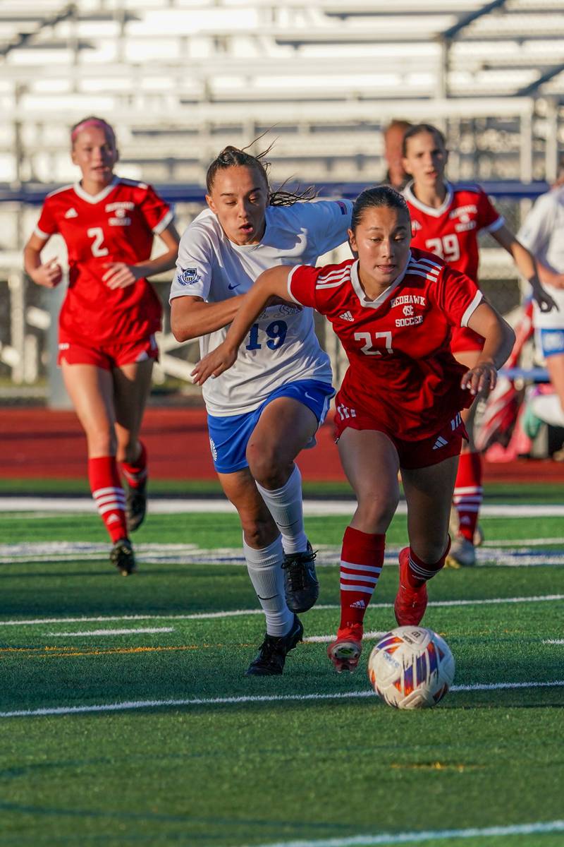 Naperville Central's Malia Shen (27) plays the ball against St. Charles North's Laney Stark (19) during a Class 3A St. Charles North Supersectional soccer final match at St. Charles North High School on Tuesday, May 28, 2024.