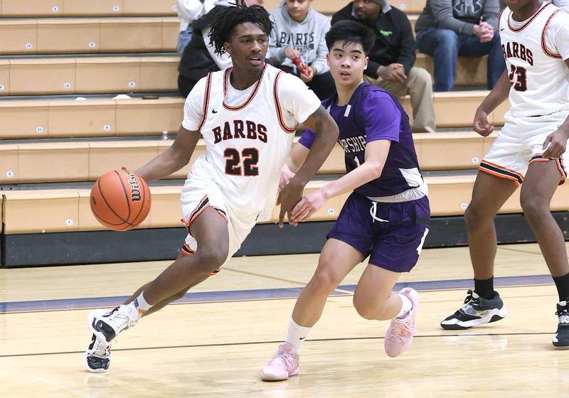 DeKalb's Darrell Island goes by Hampshire's Gavin Khounnoraj Friday, Feb. 24, 2023, during the Class 4A regional championship game at St. Charles North High School.