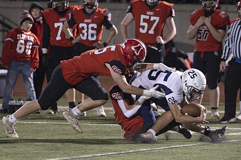 Ridgewood’s Roy Sandburg is hauled down by Amboy’s Brennen Blain and Brayden Klein during the I8FA championship Friday, Nov.17, 2023 at Monmouth College