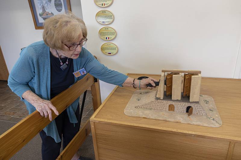 Jane Luker shows off an unusual windmill model Friday, June 7, 2024 at the Fulton Windmill Cultural Center.