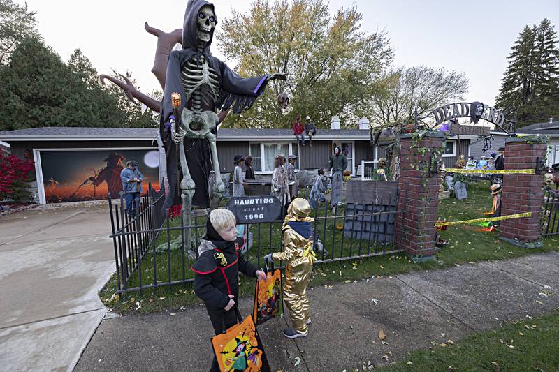 Kaspen (left), 6, and Ashur Hicks, 6,  check out the scene at Dave and Mary Lally’s home in Dixon Tuesday, Oct. 31, 2023. Dave regularly decorates big for Halloween.