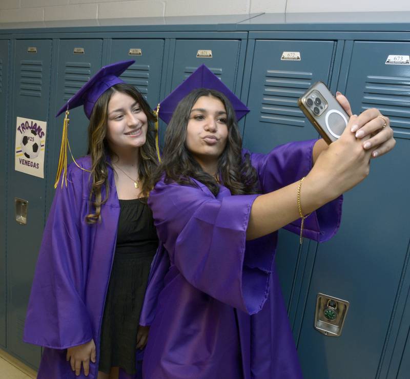 Alysa Sharp and Kiara Johnson take a photo to remember as they get ready for their graduation ceremony Saturday at Mendota High School.