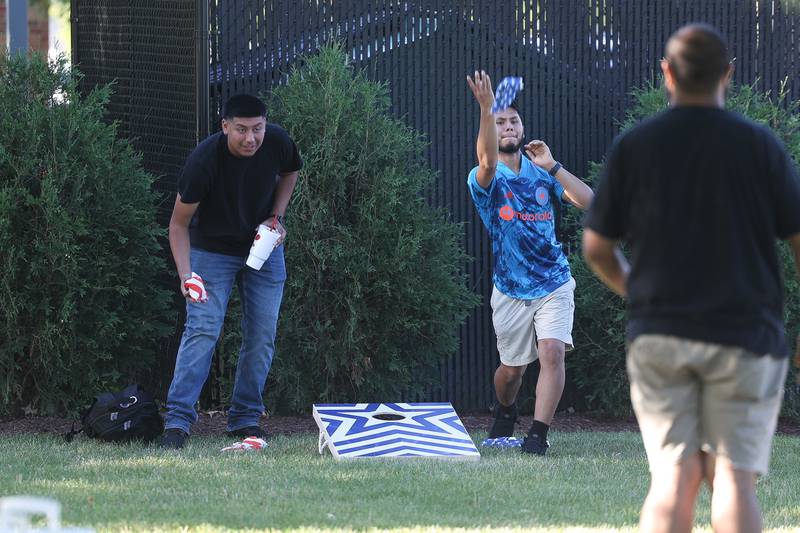 Cesar Gutierrez, left, and German Lopez play a game of bags at Dellwood Park in Lockport on Wednesday July 3, 2024.