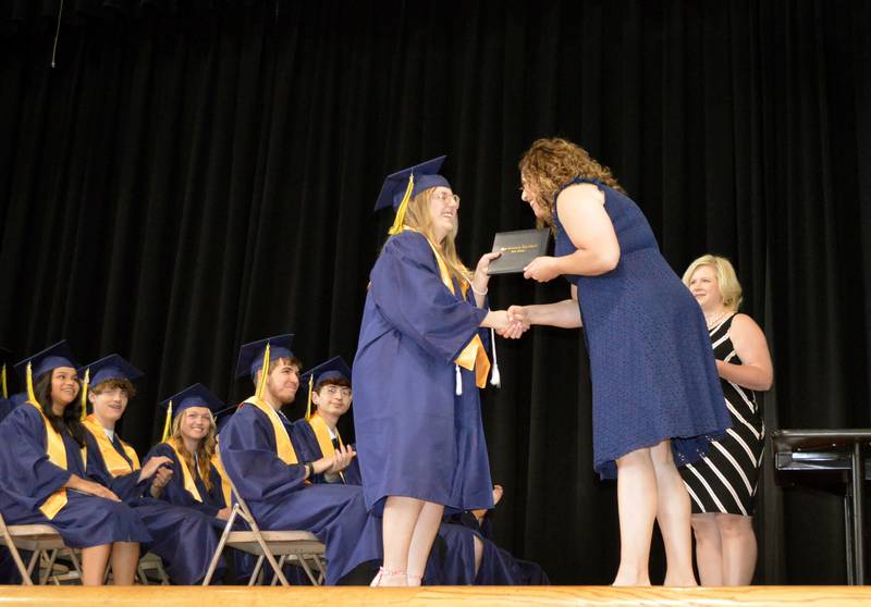 Polo Community High School senior Avery Faivre, left, accepts her diploma from PCHS Board of Education member Jennifer Grobe during the Class of 2024's commencement ceremony on Sunday, May 19, 2024.