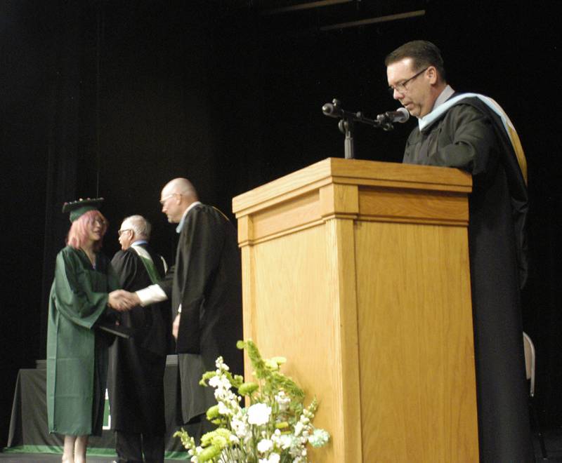 Rock Falls School Board President Merle Gaulrapp, Superintendent Ron McCord and Principal Mike Berentes present diplomas to the Rock Falls High School Class of 2024 on Sunday, May 26, 2024.