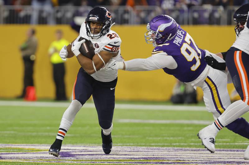 Chicago Bears running back Roschon Johnson runs from Minnesota Vikings defensive tackle Harrison Phillips during the second half, Monday, Nov. 27, 2023, in Minneapolis.