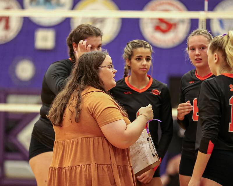 Sandwich's head coach Amy Rogowski instructs the team during a timeout in their volleyball match at Plano.  August 21, 2023.