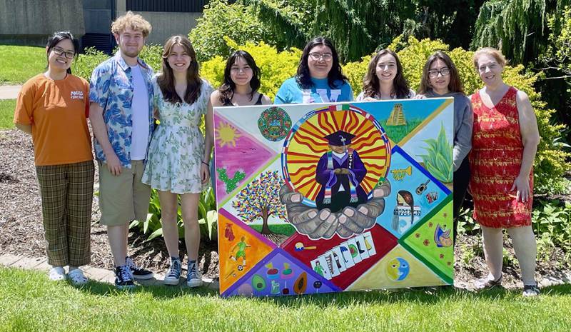 The Hispanic Leadership Team at Illinois Valley Community College exhibits a newly completed cultural heritage mural Wednesday, May 1, 2024. The mural is now displayed in a hallway leading to the Student Life Space. Presenting the artwork are (from left) Emily Tran, Ashton Watkins, Emma Coss, Ariana Benitez, Jennifer Cortes, Allayna Elnicki, Azul Flores and Lynn Keyt.